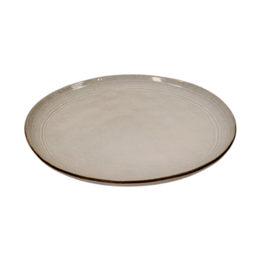Four Candle Satchville stoneware dinner plate in off-white with a rustic brown rim on a white wooden table.