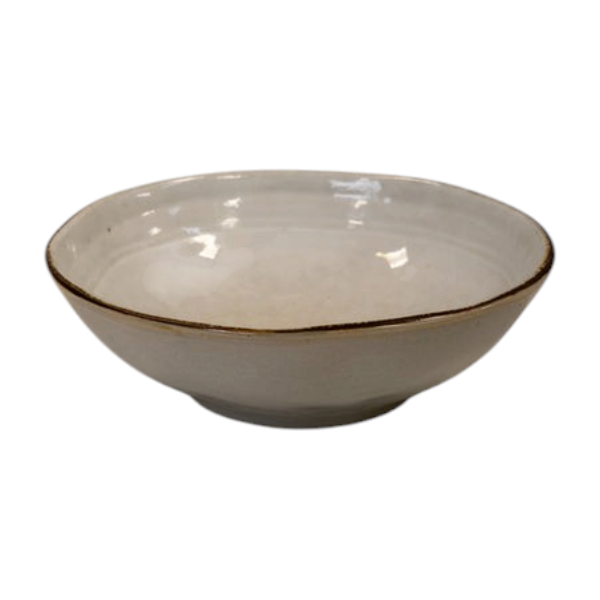 Four Candle Satchville stoneware cereal bowl in off-white with a rustic brown rim on a white wooden surface.